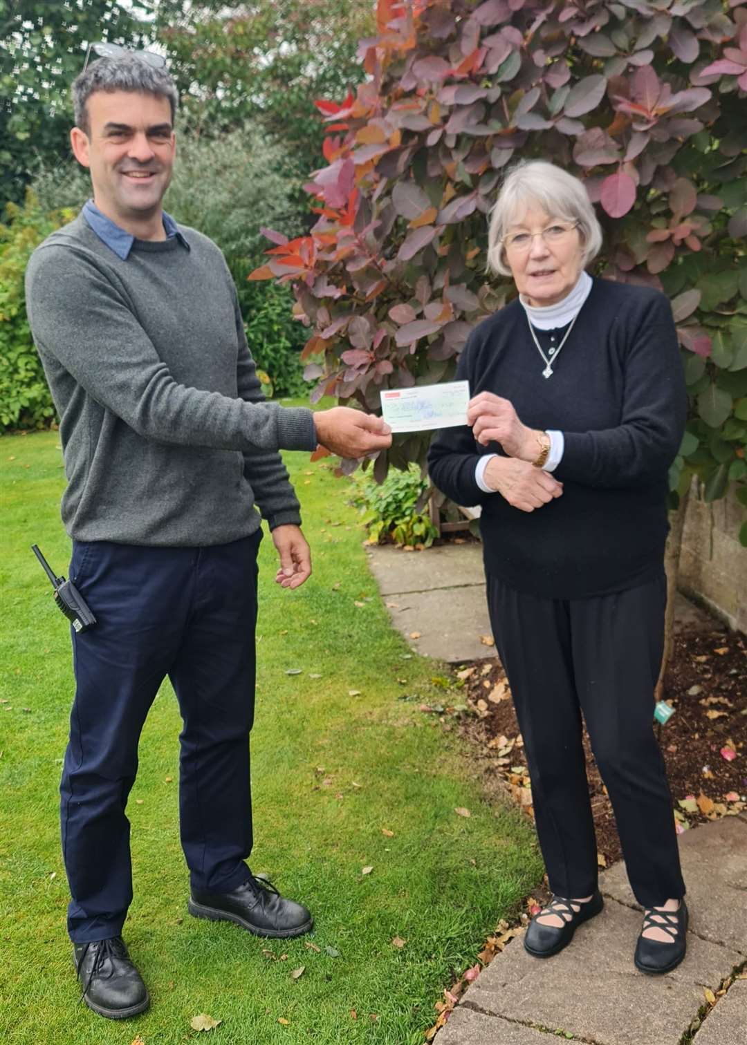 Izzie MacDonald presenting the cheque to Botanic Gardens manager Ewan Mackintosh.