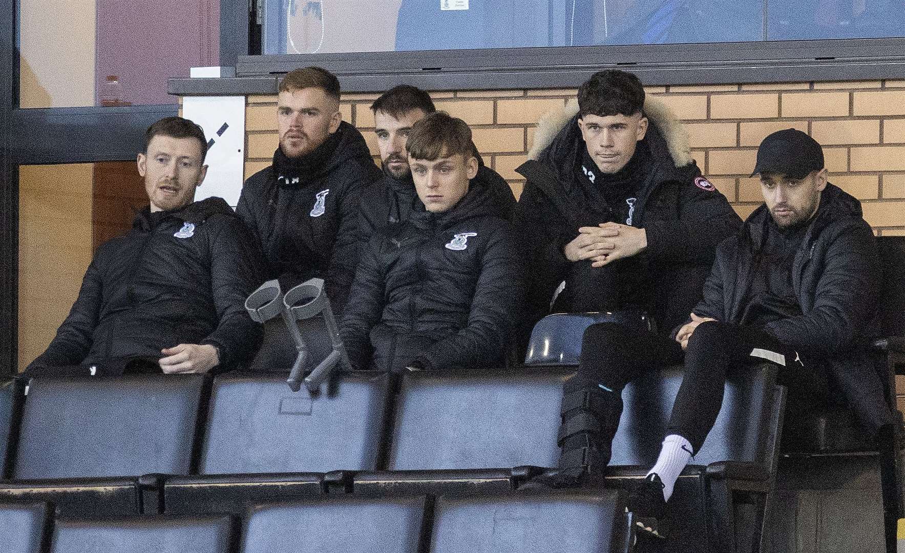 A seat in the stand has been an all too familiar berth for MacGregor (centre, with crutches), here in November 2022.