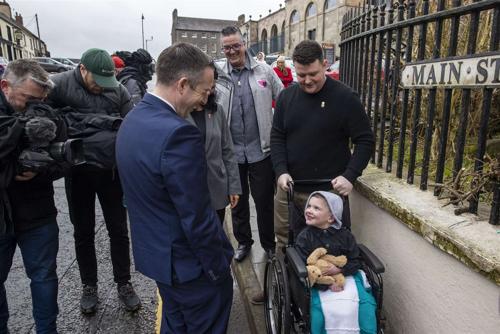 Paul Givan (left) meets with Mairtin MacGabhann (right) and his six-year-old son Daithi MacGabhann (Liam McBurney/PA)