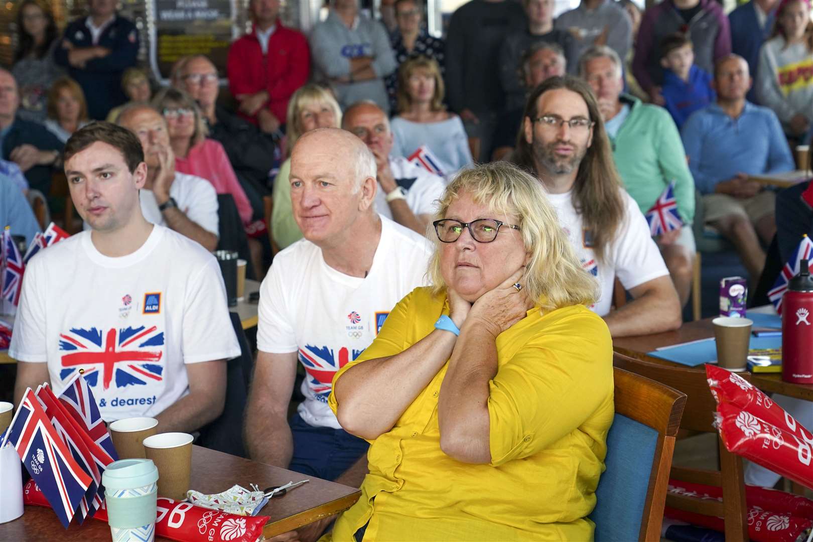 Eilidh McIntyre’s fiance Jonny Forer (left), father Mike McIntyre, and mother Caroline McIntyre watch on the big screen at Hayling Island Sailing Club (Steve Parsons/PA)