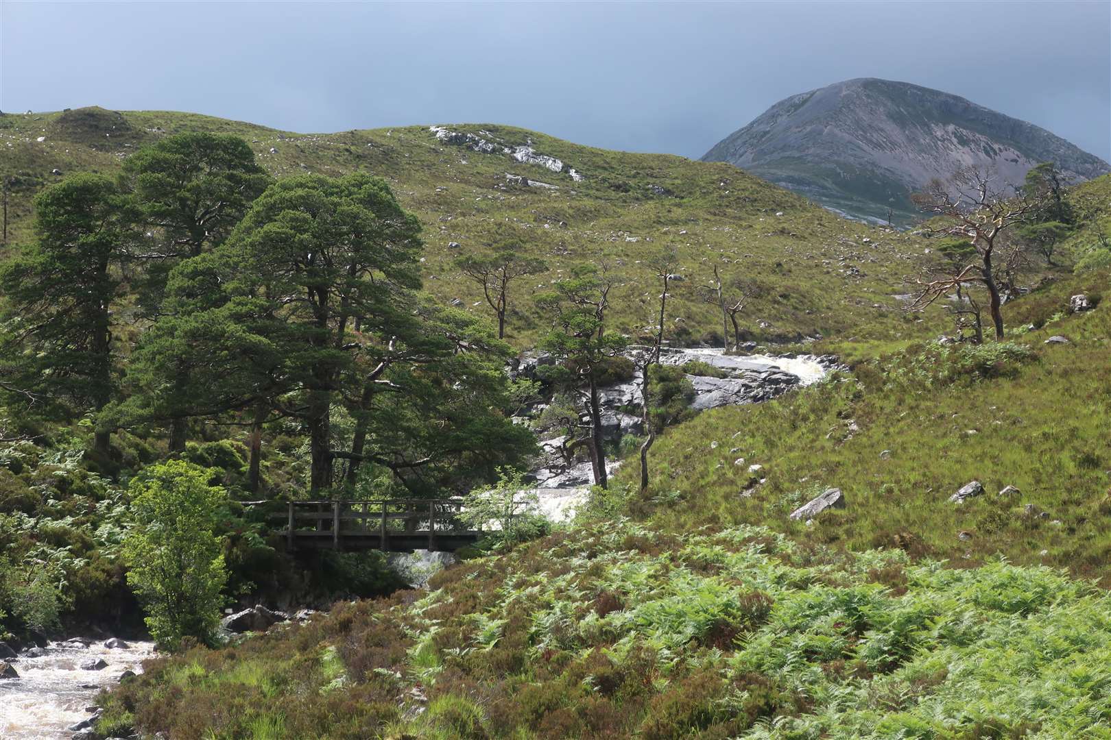Footbridge and waterfall on the Easan Dorcha with Beinn Liath Bheag beyond.