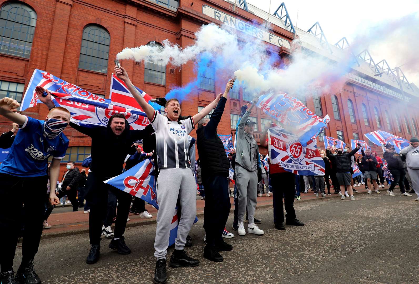 Rangers fans celebrate outside Ibrox Stadium (Jane Barlow/PA)
