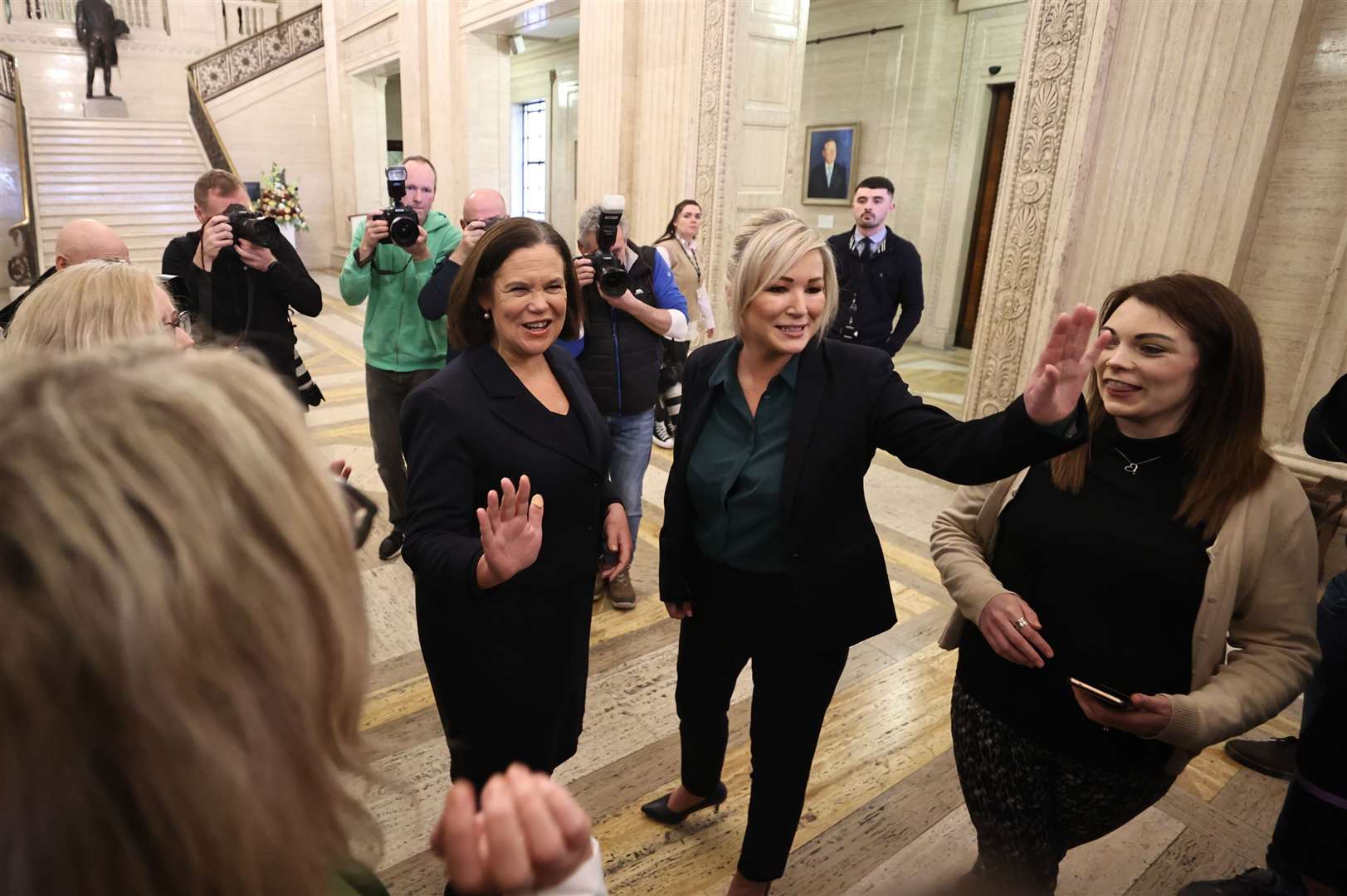 Sinn Fein president Mary Lou McDonald (centre) and vice president Michelle O’Neill wave after speaking to students from Mount Lourdes Grammar in Enniskillen at Stormont (Liam McBurney/PA)