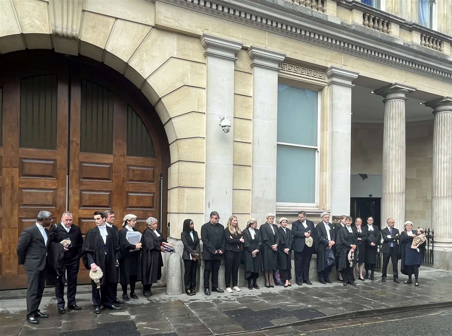 Criminal barristers from the Western Circuit line up outside Bristol Crown Court (Rod Minchin/PA)