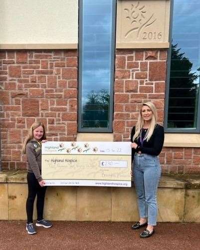 Breagha giving the cheque to Karen Duff at the Highland Hospice.