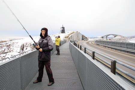 Ron Smith tries his hand at fishing off a Norwegian bridge.