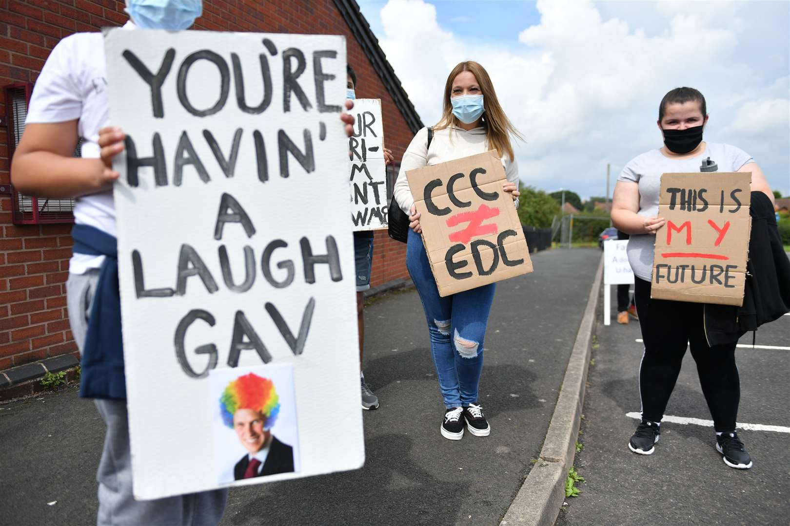 Students from Codsall Community High School gather prior to marching to the constituency office of Gavin Williamson as part of a protest over A-level results (Jacob King/PA)