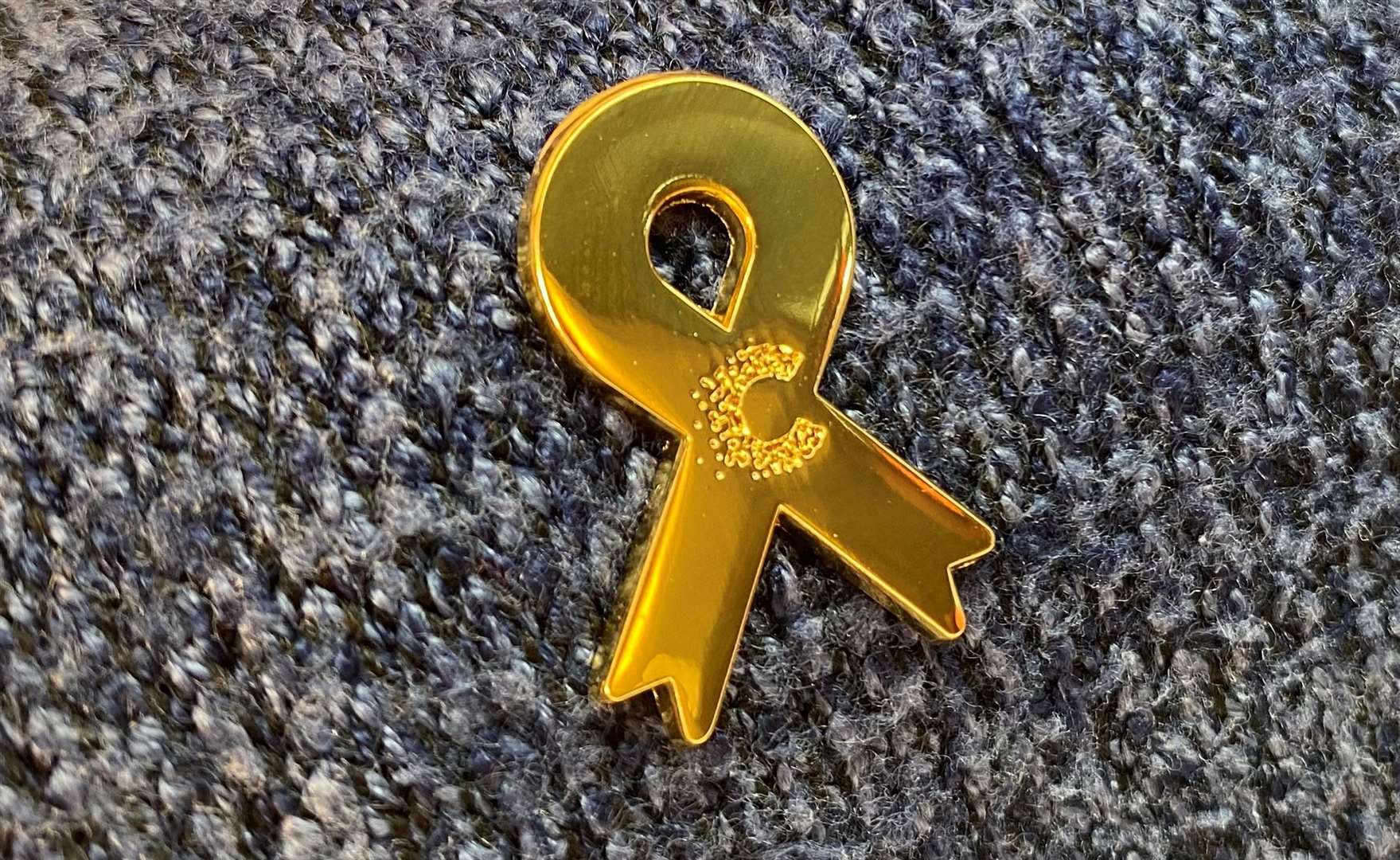Symbol of childhood cancer awareness month.