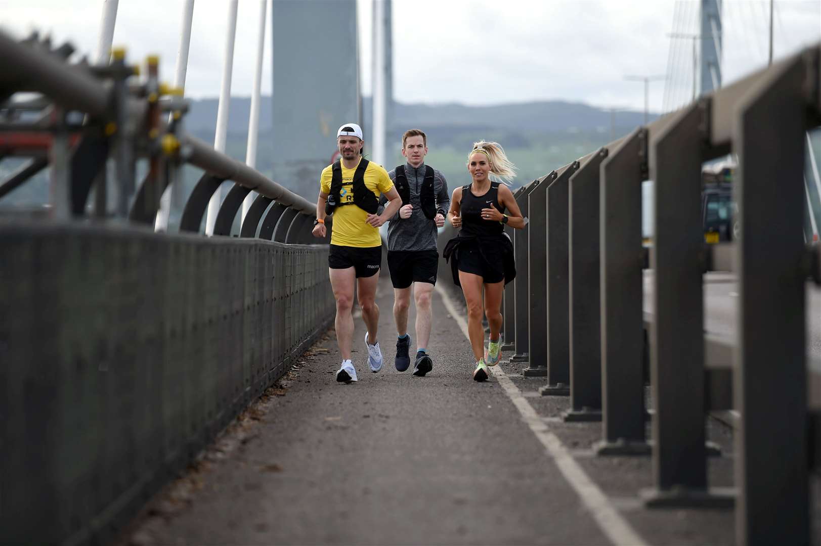 Steven Mackay, in the yellow top, who is running the 516 miles of the NC500 in just 10 days. Crossing the Kessock Bridge with Andrew Macleod and Kellie Calder who are running the first section to Golspie. Picture: Callum Mackay