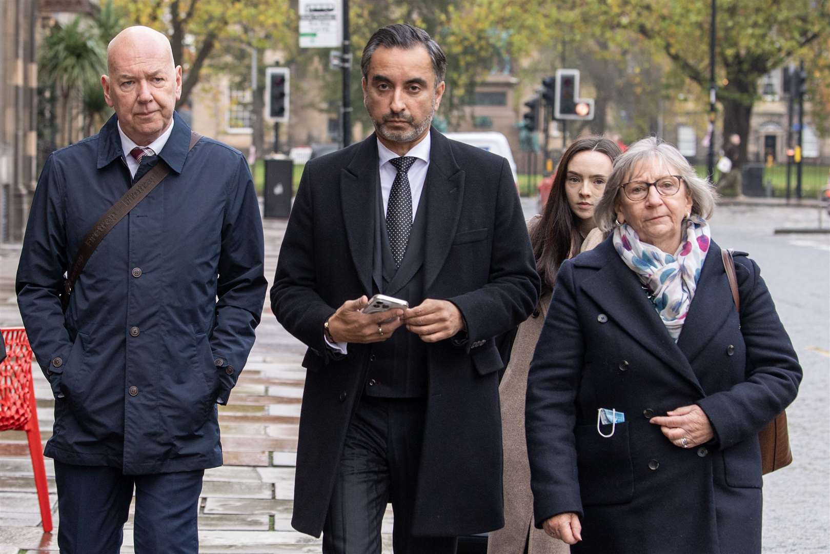 Bereaved relatives Alan Inglis (left), Margaret Waterton (right) and lead solicitor for Scottish Covid Bereaved Aamer Anwar (centre) arrive for the hearing (Lesley Martin/PA)