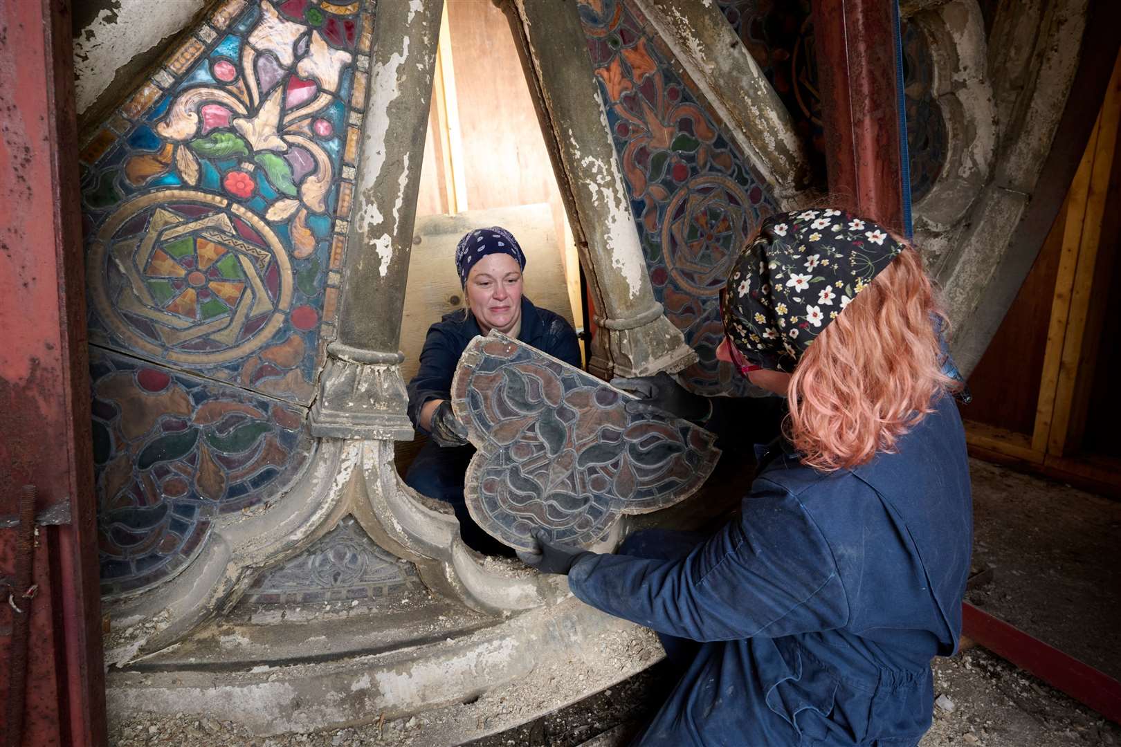Alison Milligan ACR, Specialist, Iona Art Glass and colleague removing panels from the Rose Window for refurbishment. Picture: Ewen Weatherspoon Photography.