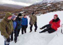 Keith Miller and some of the WinterFest participants talk about the snow conditions at a pit on the slopes above Cluanie in Glen Shiel.