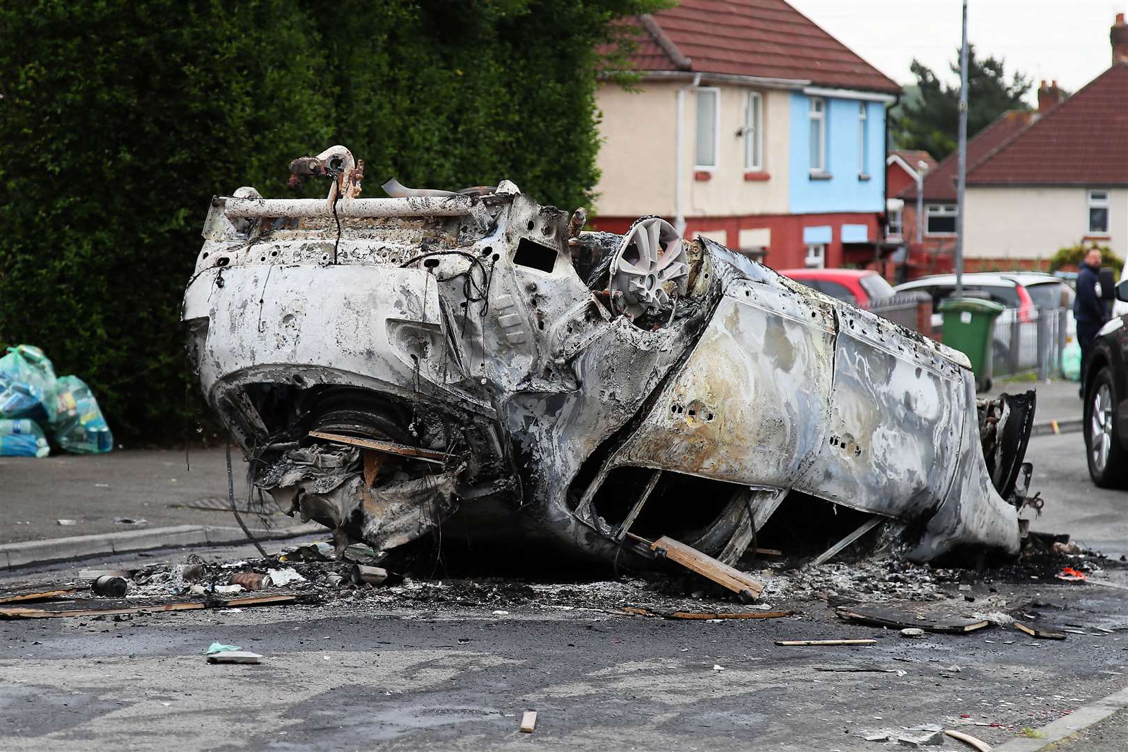 The car that was set alight in Ely, Cardiff, following the riot that broke out after two teenagers died in a crash (PA)