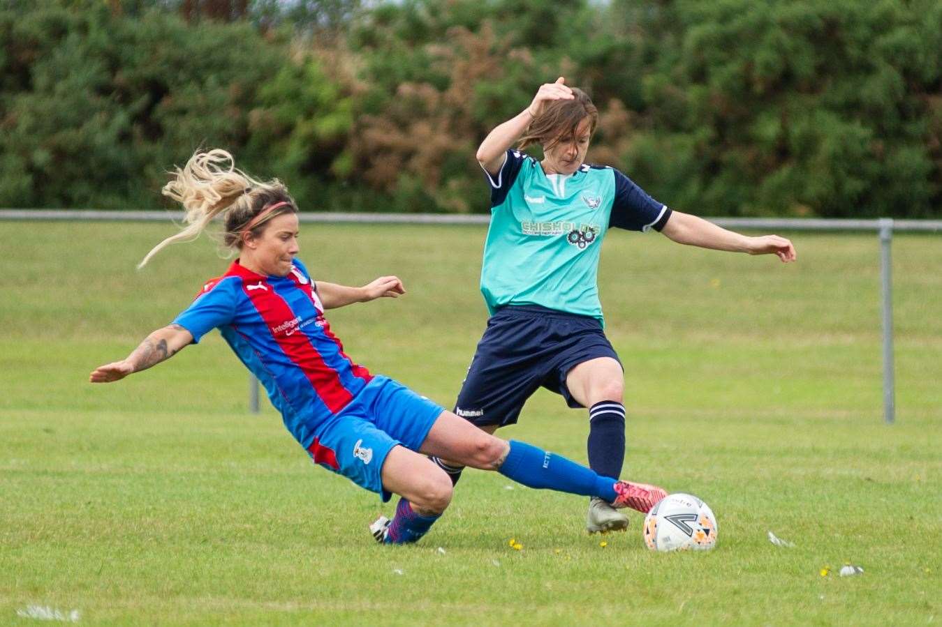 Inverness Caledonian Thistle's Amy Lee Davidson slides in for a challenge on Buckie Ladies' Gemma Geddes. Picture Daniel Forsyth.