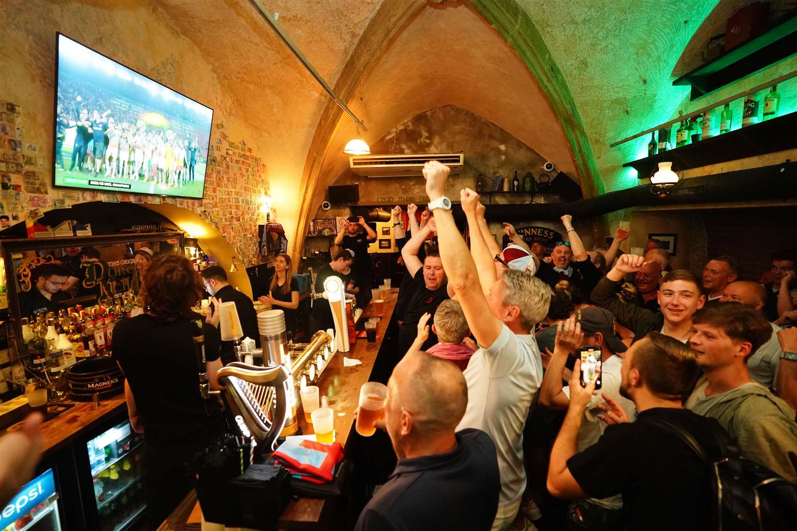 West Ham United fans watch the trophy presentation in a pub in Prague, following the Uefa Europa Conference League final (James Manning/PA)
