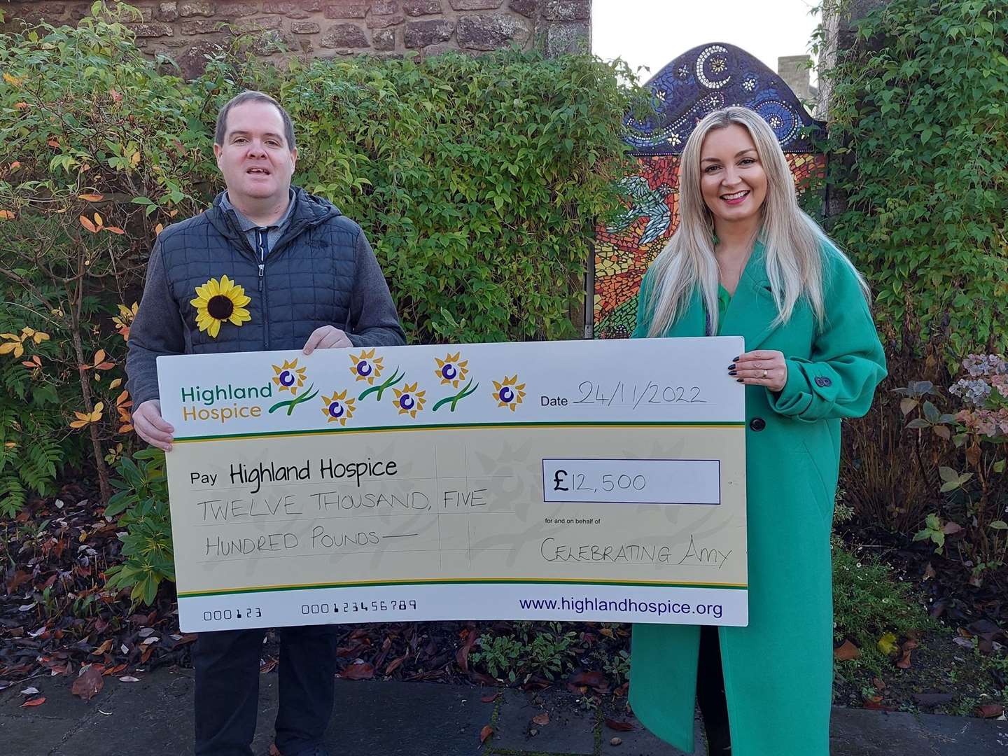 Gary Tuach hands over £12,500 to Highland Hospice. The same sum went to Mikeysline.