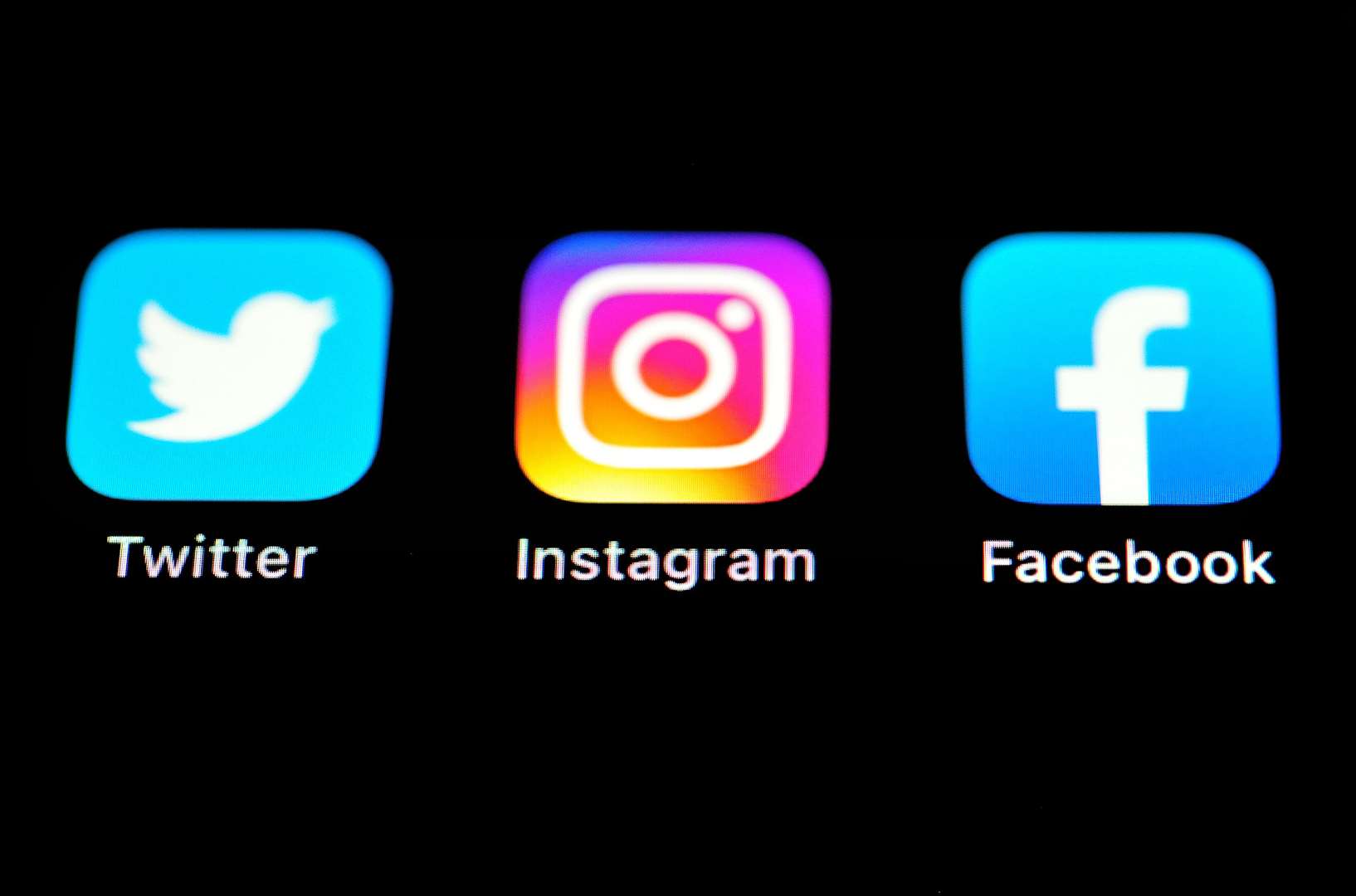 A view of the Twitter, Instagram and Facebook apps on an iPhone screen (Matthew Vincent/PA)