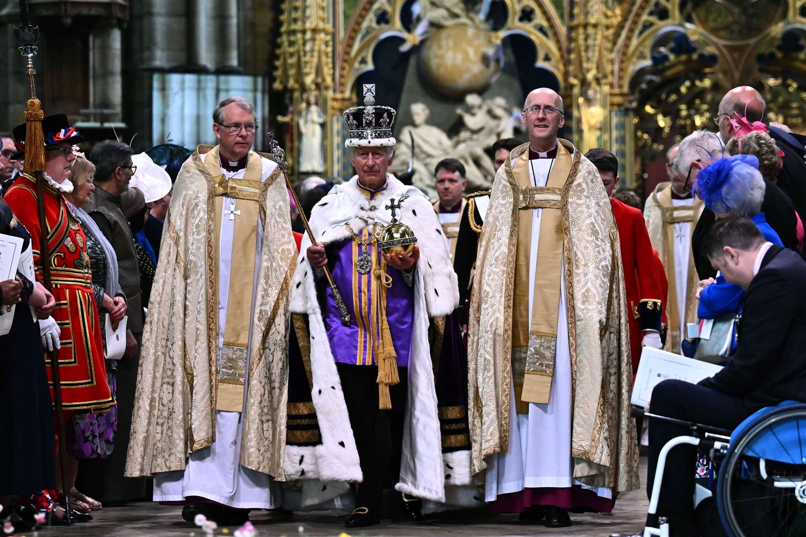 The King carrying the Sovereign’s Orb and Sceptre leaves Westminster Abbey (Ben Stanstall/PA)