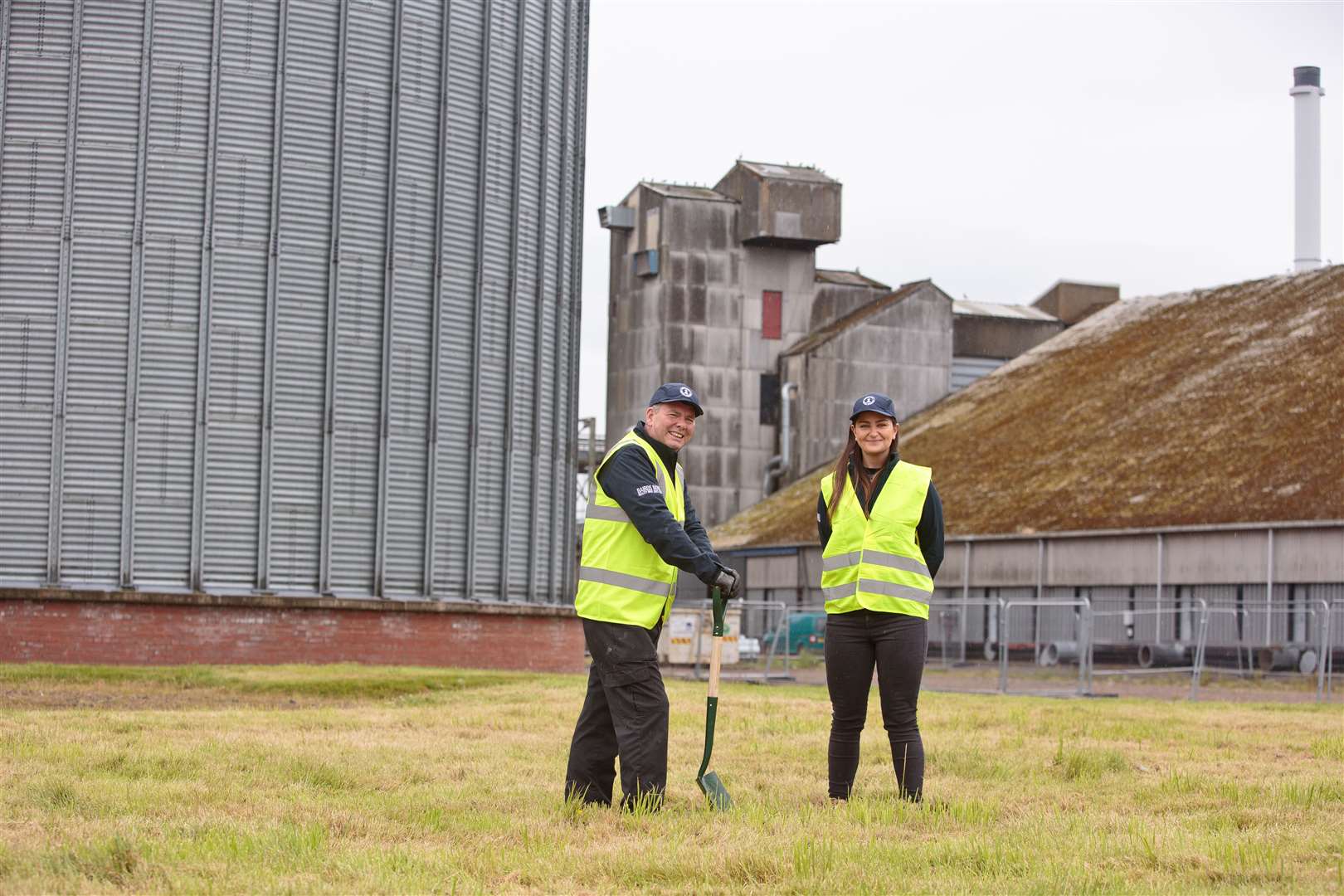 Senior malt technician Alex Glass and Isla Prentice, project coordinator for Bairds Malt, signal the start of expansion work at the maltings in Inverness.