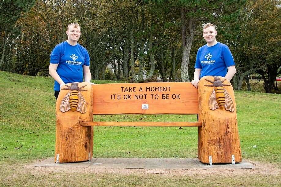 Mikeysline community volunteers Ross (left) and Callum Kinnaird with one of the new benches. Picture: Chris MacInnes Photography