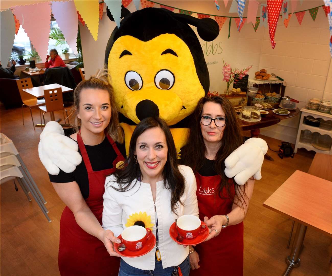 Kindness launch at Cobbs..Hospice mascott Bobby the Bee gives out hugs and a cuppa to Hannah Walton and Cheryl McKenzie of Cobbs with Francesca Marchetti of Highland Hospice...Picture: Gary Anthony..