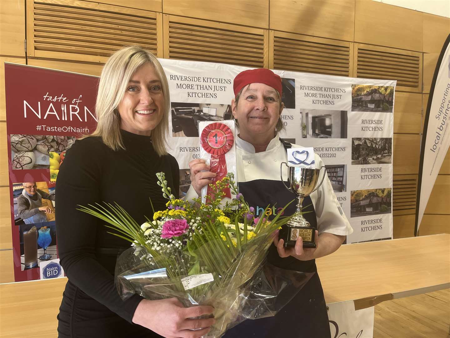 Vicky Farquhar presents Donna Cunningham with her prizes after scooping the world tattie scone title.