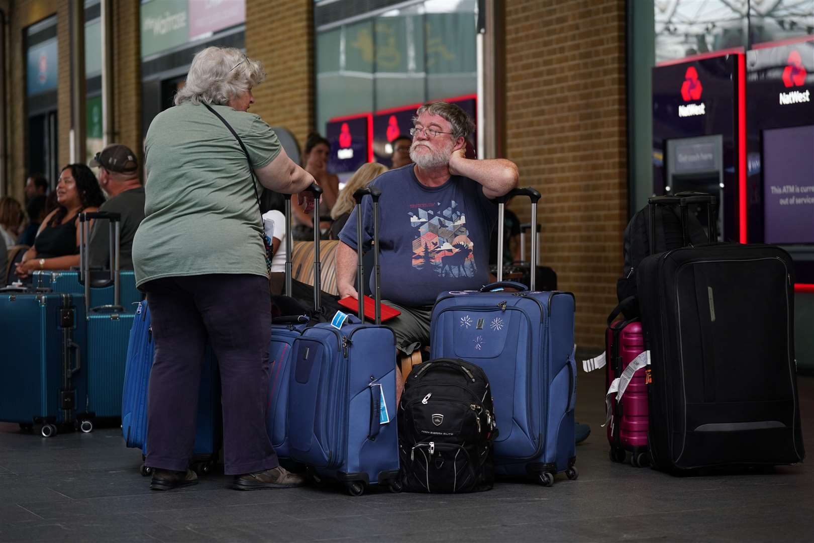 Passengers waiting at King’s Cross station in London (Yui Mok/PA)