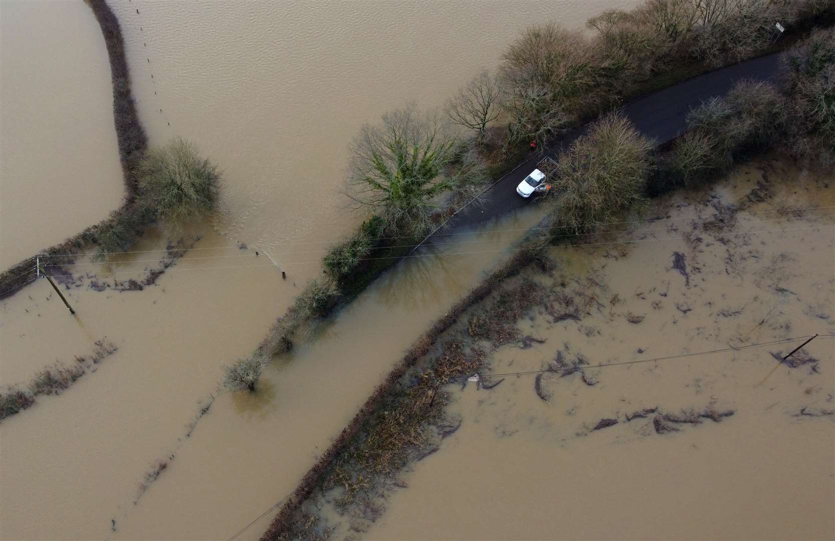 A van avoids floodwater from the River Ouse in Barcombe Mills, East Sussex (Gareth Fuller/PA)