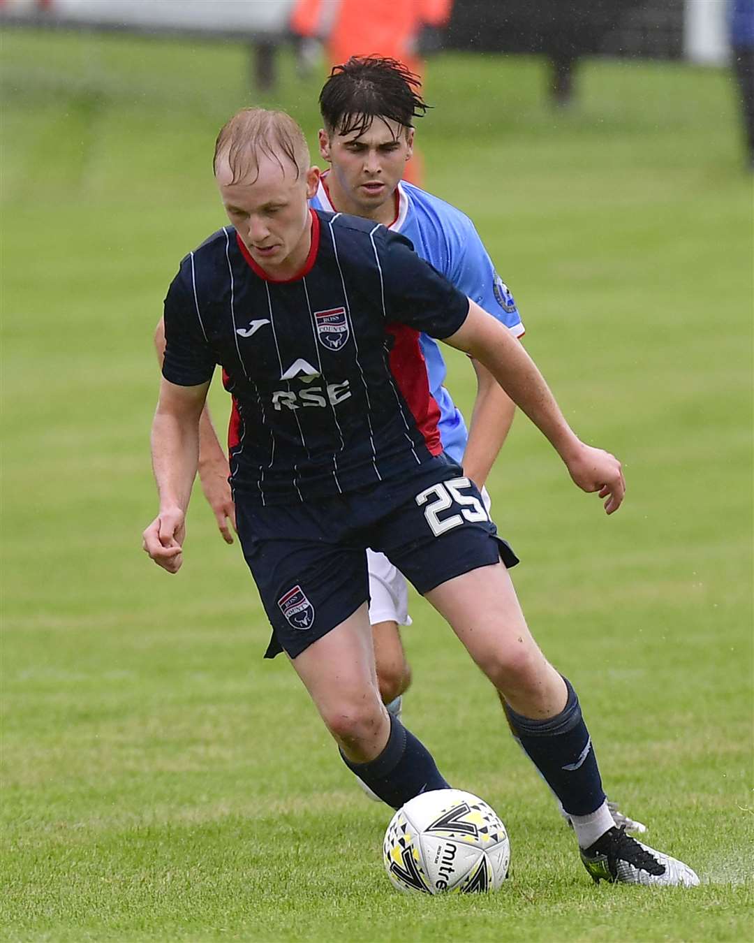 Ross County's Ethan Kevill and Wick's Gary Pullen at Harmsworth Park in July this year.