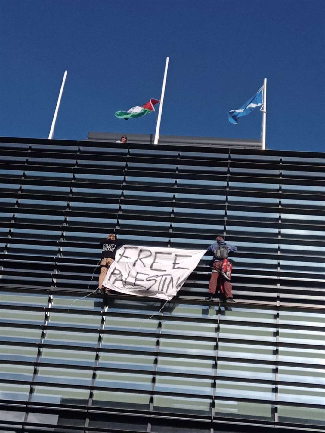 Activists unfurled a Palestinian flag on the roof of the UK Government building (This Is Rigged/PA)
