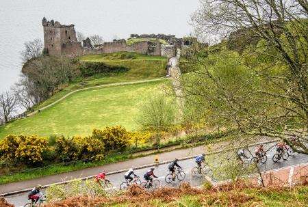 Riders follow the closed A82 alongside Urquhart Castle.