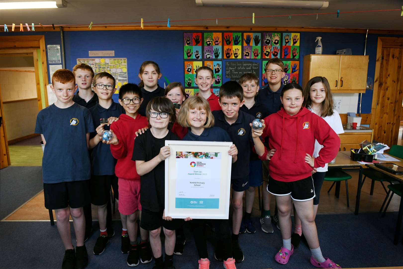 P6 pupils with one of the awards and some of the digital technology. Picture: Callum Mackay