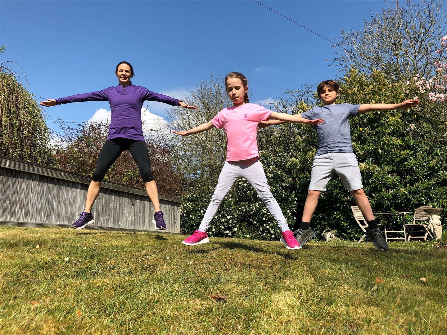 Jacob and Emily join their mum Jo Pavey with some exercises in the garden. Picture: Gavin Pavey/PA