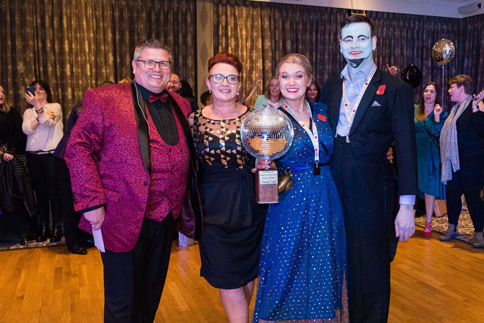 Gordon Michie, Jennifer Hill, Caitlin Murray and Paul Robertson with the coveted Glitterball Trophy at Come Dancing with Poppyscotland.