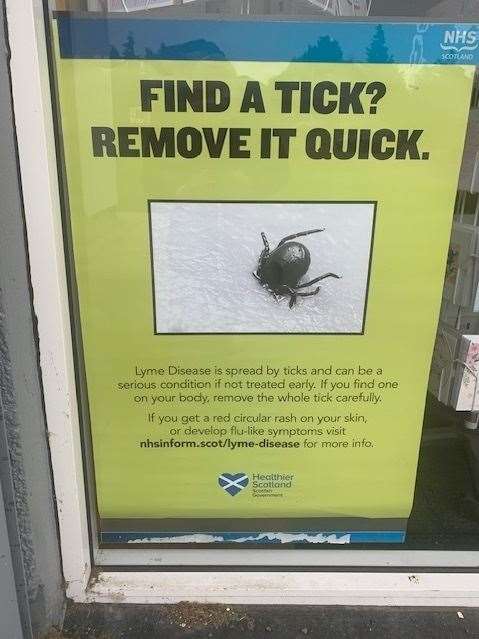 Tick warning sign in Lochardil pharmacy window.