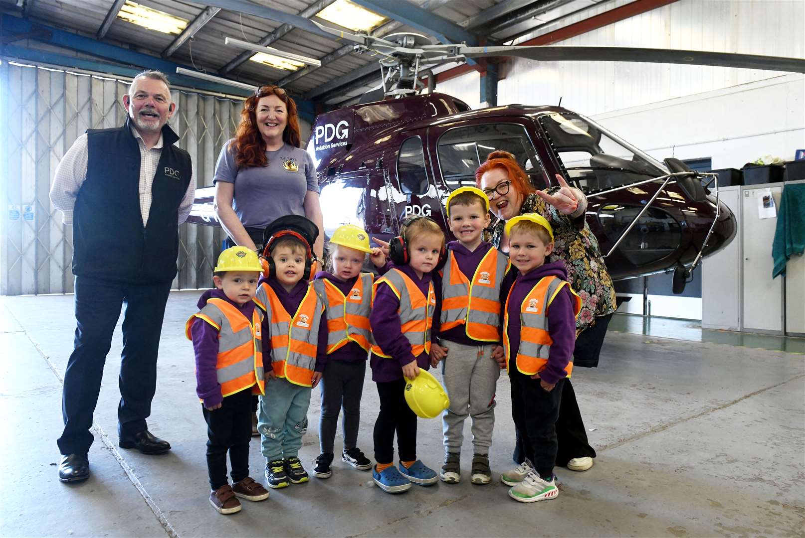 Shaun Strain, CEO of PDG Aviation Services, Tina Strain, Owner of Tintins Early Learning & Childcare and Marion Irvine, Assistant Manager with Tommy Barnett, Brodie Connell, Arla Fraser, Ozzy Clark, Brodie Mackay and Jackson Lee. Picture: James Mackenzie.