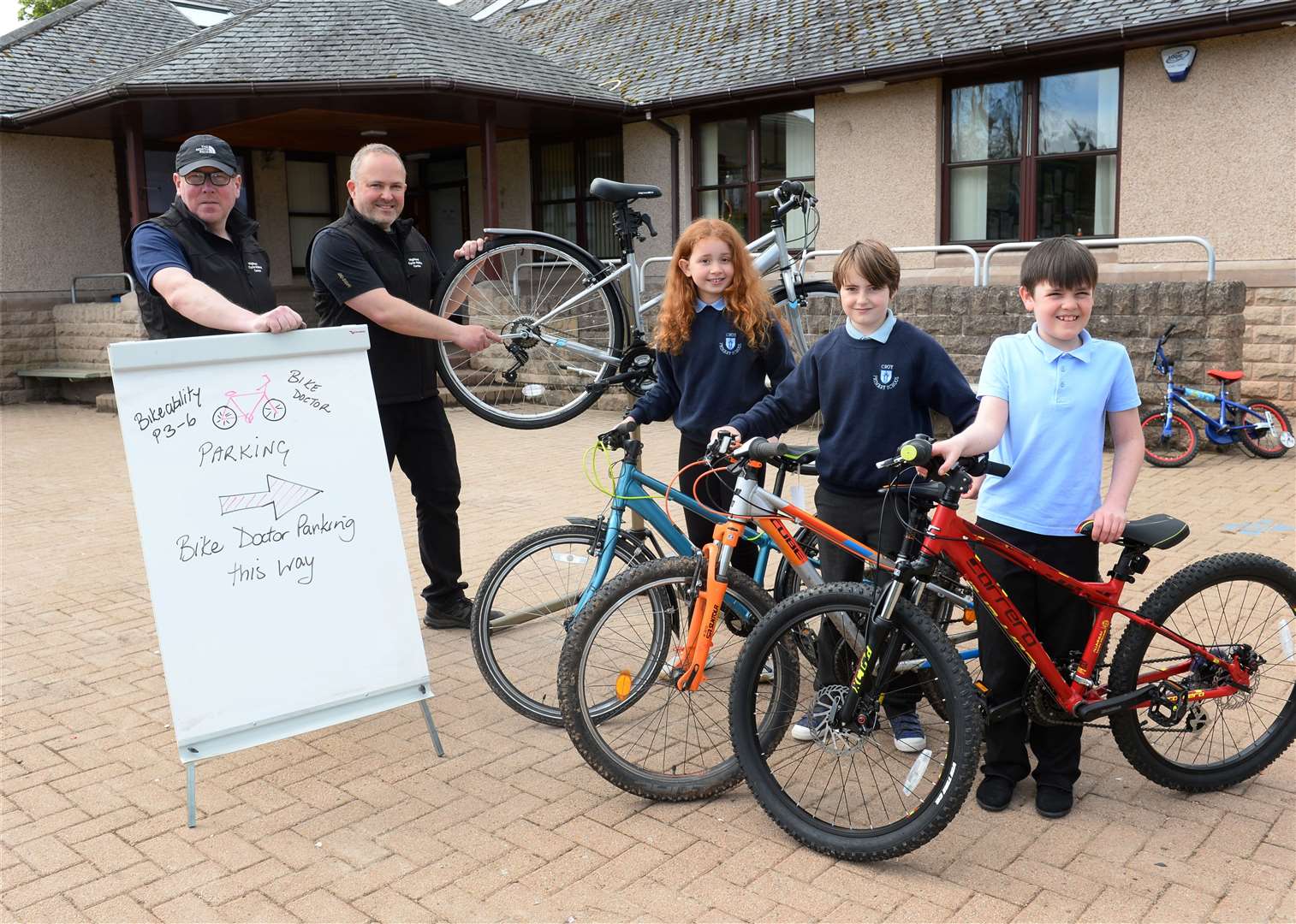 Bike doctors Iain Bamber(left)and Nick Brown with P5 pupils Eva Simpson,Evie Strachan and Lucas Thomas. Picture: Gary Anthony