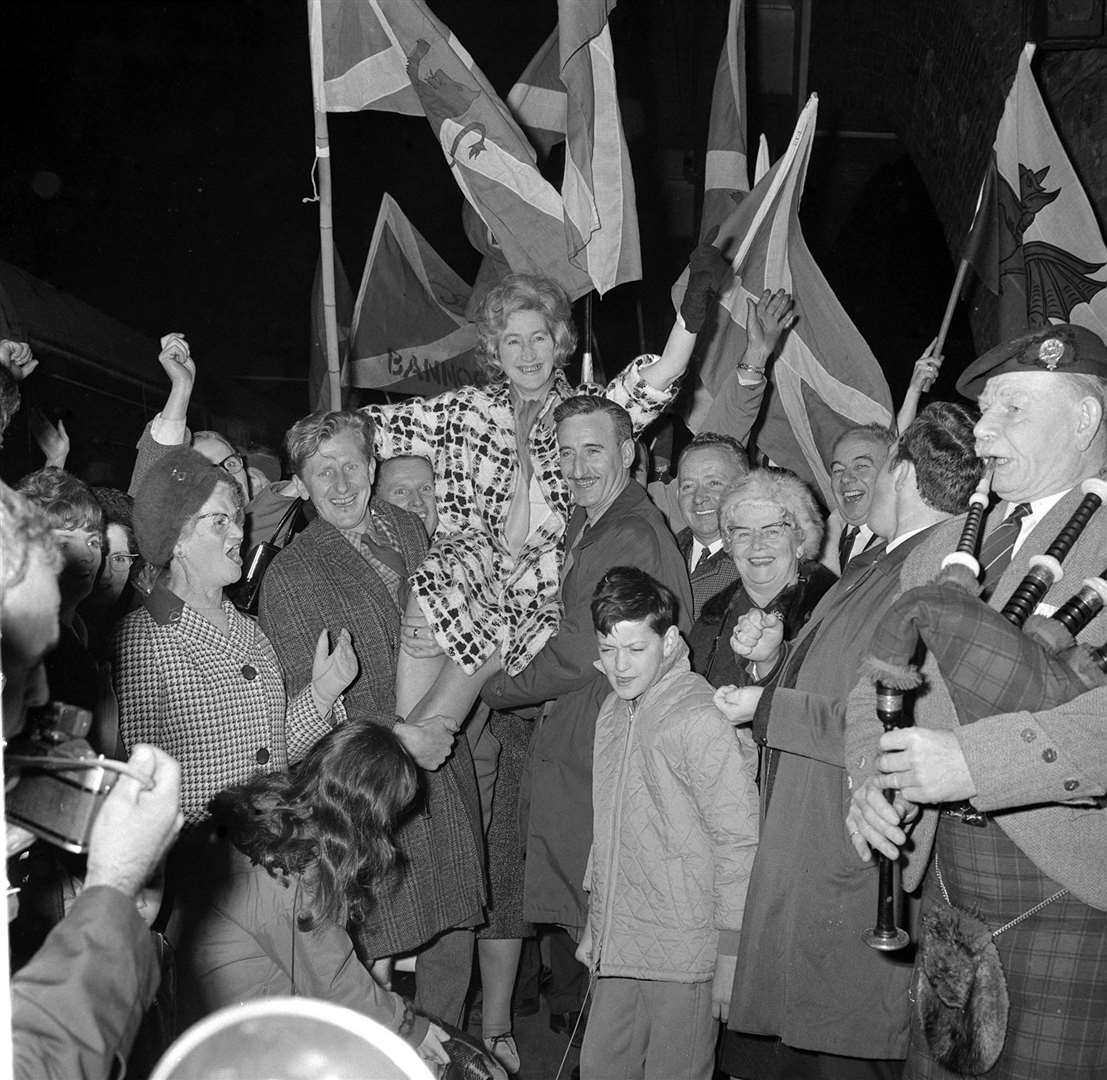 The sound of the bagpipes and a waving of Scottish flags to announce the arrival at King’s Cross Station, London, of Winnie Ewing, the new MP for Hamilton after her 1967 victory (PA Archive)