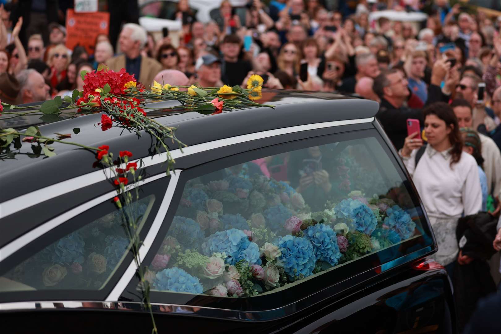 The Irish singer’s funeral cortege passes through her former home town of Bray, Co Wicklow, ahead of a private burial service (Liam McBurney/PA)