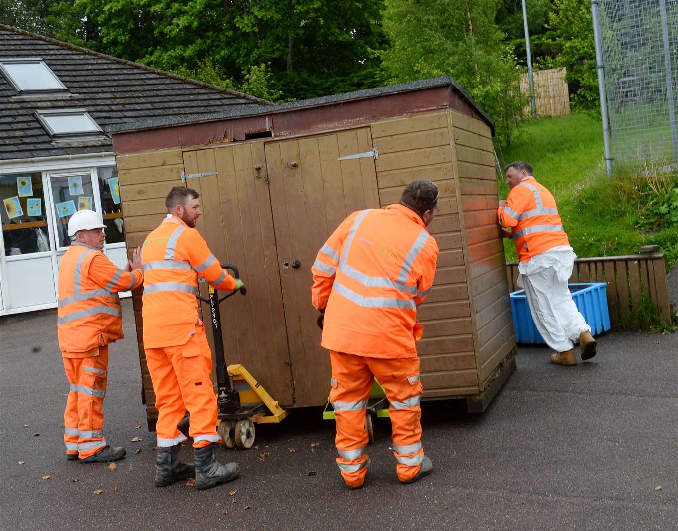 A squad of volunteers from the local BAM Nuttal works undertaking voluntary maintenance works around Cradlehall Primary.Team get shed on the move.Picture Gary Anthony.