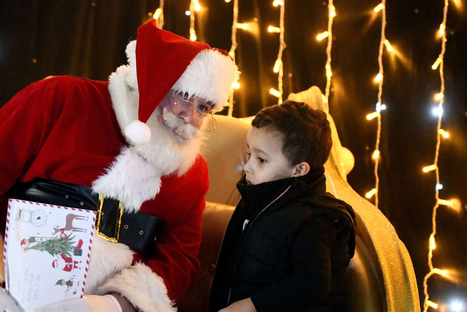 Santa speaking with a child. Picture: James Mackenzie.