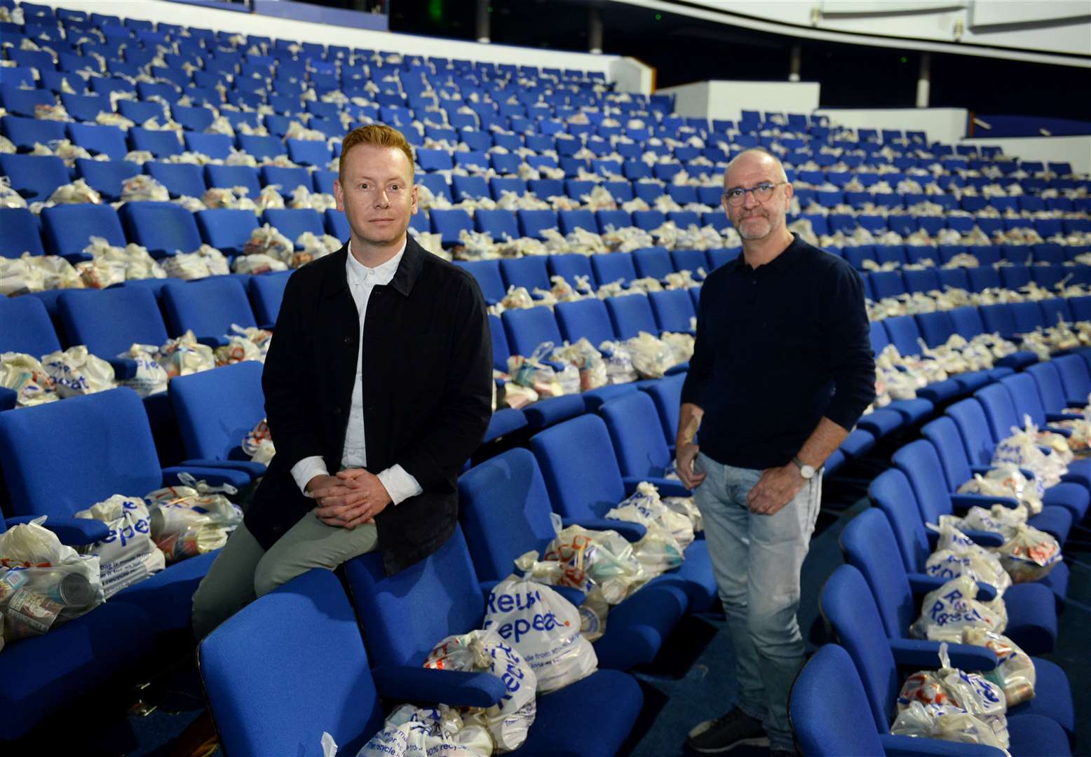 James Mackenzie-Blackman with Steven Wren in the theatre as it was transformed into a distribution hub for food packages.
