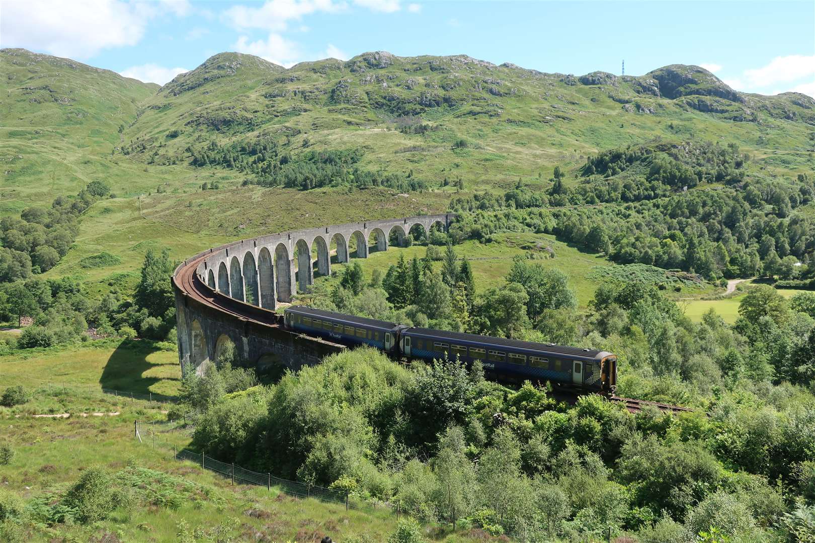 The ScotRail train passes over the viaduct..