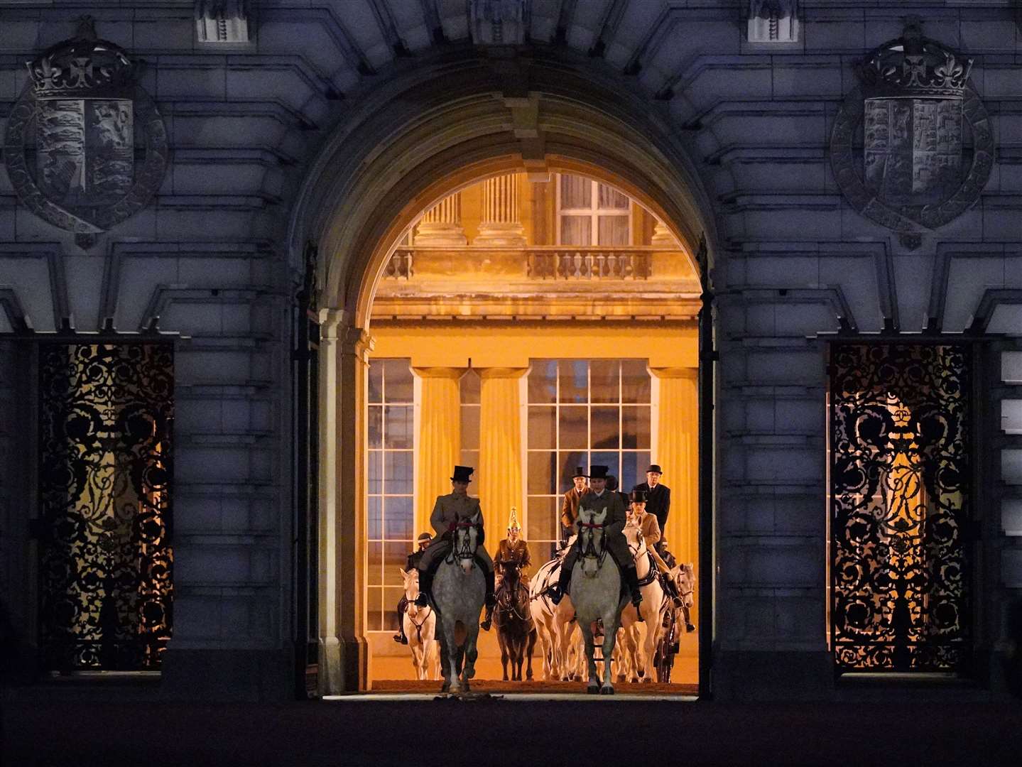 Members of the military depart Buckingham Palace, central London, during a night time rehearsal for the coronation (Yui Mok/PA)