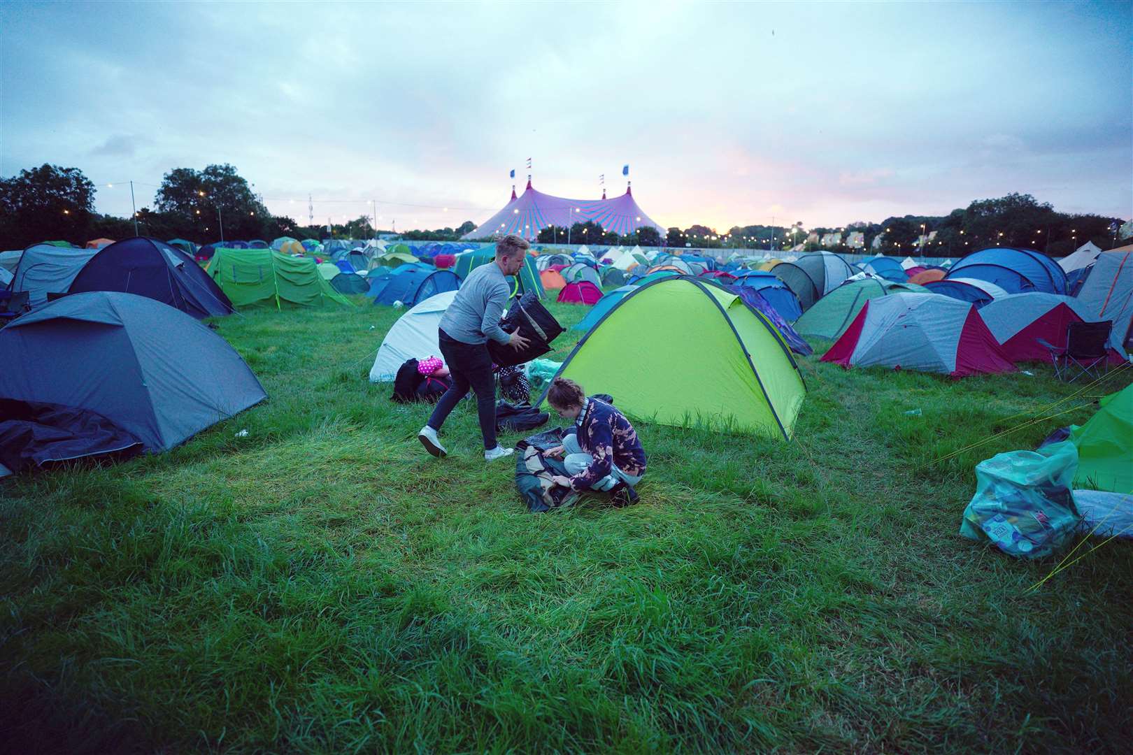 Festival-goers pack away their pitch (Ben Birchall/PA)