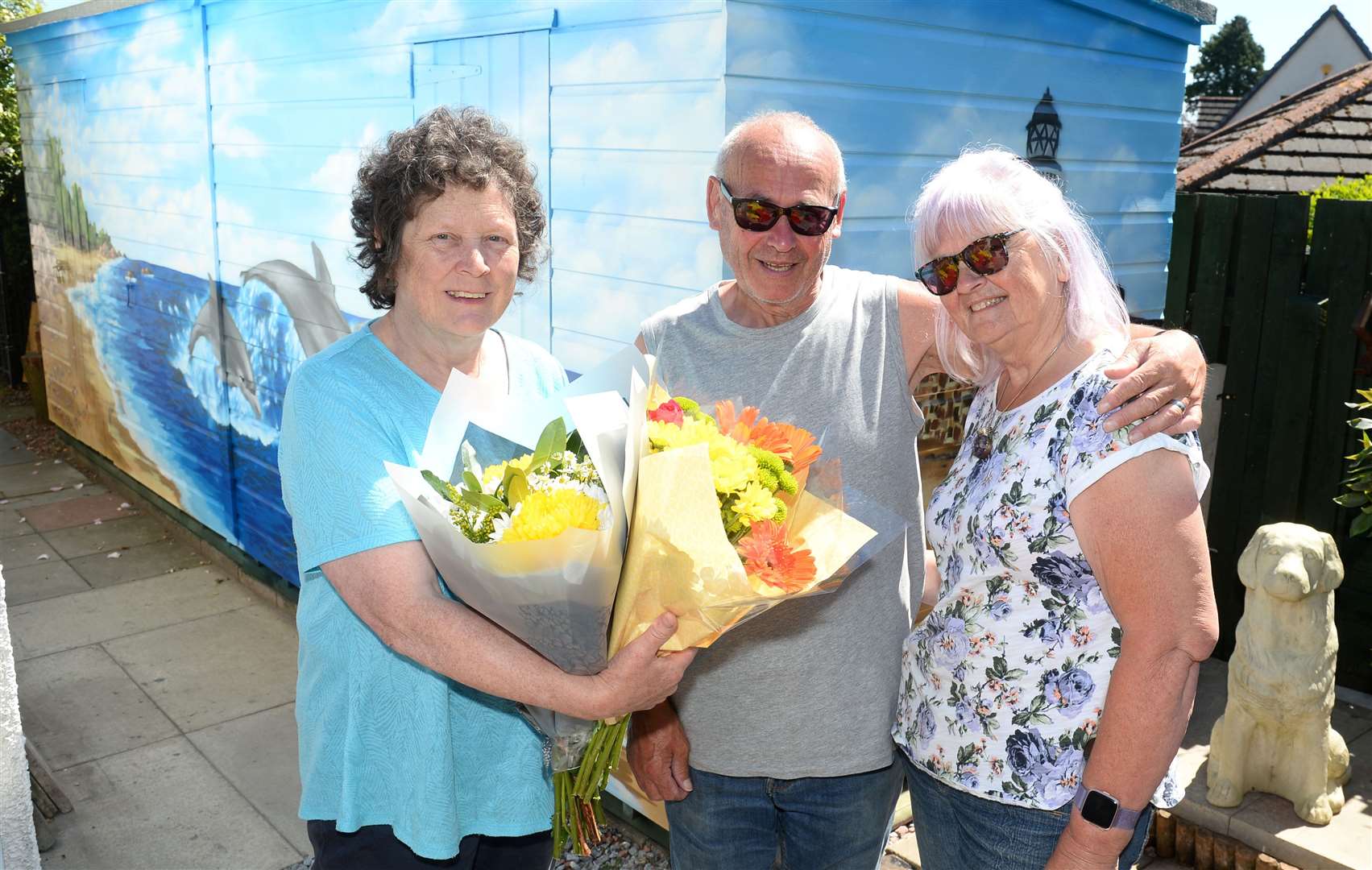 Iona Nicol presents Rhona Dalgarno and partner Jimmy Doull with flowers for their super fundraising efforts.Picture: Gary Anthony.
