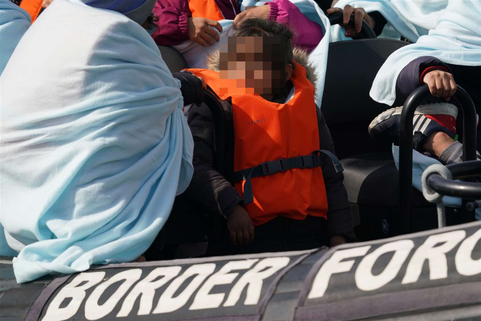 A child among a group of people on a Border Force vessel after a small boat incident in the Channel (Gareth Fuller/PA)