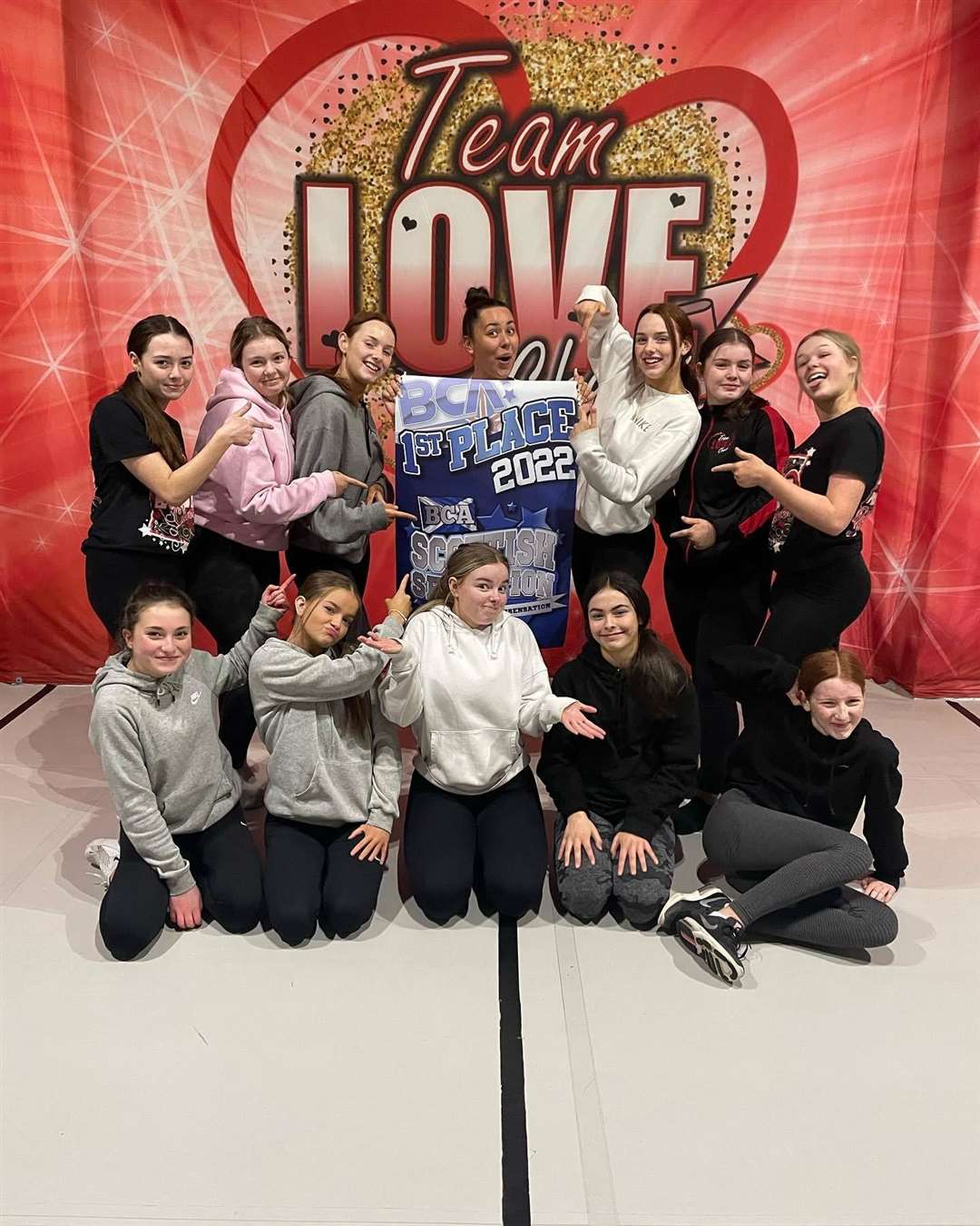 Senior hip hop team, the TLC Heartbreakers with the winning banner.
