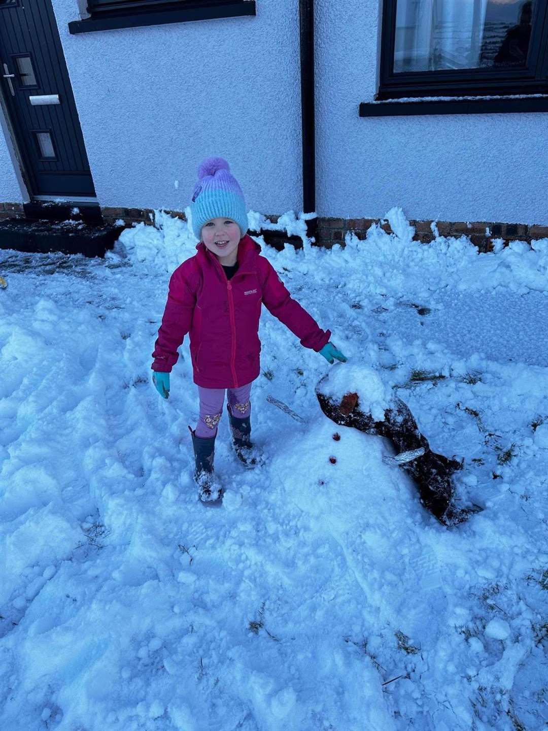 Three-year-old Ayla Windsor in Culbolkie with a snowman.