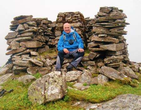 Peter at the trig point on the summit of Carn Breac.